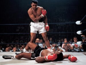 Muhammad Ali sobre Sonny Liston após seu golpe fantasma. A ira de Ali demonstra que ele acaba de vencer seus vieses subconscientes